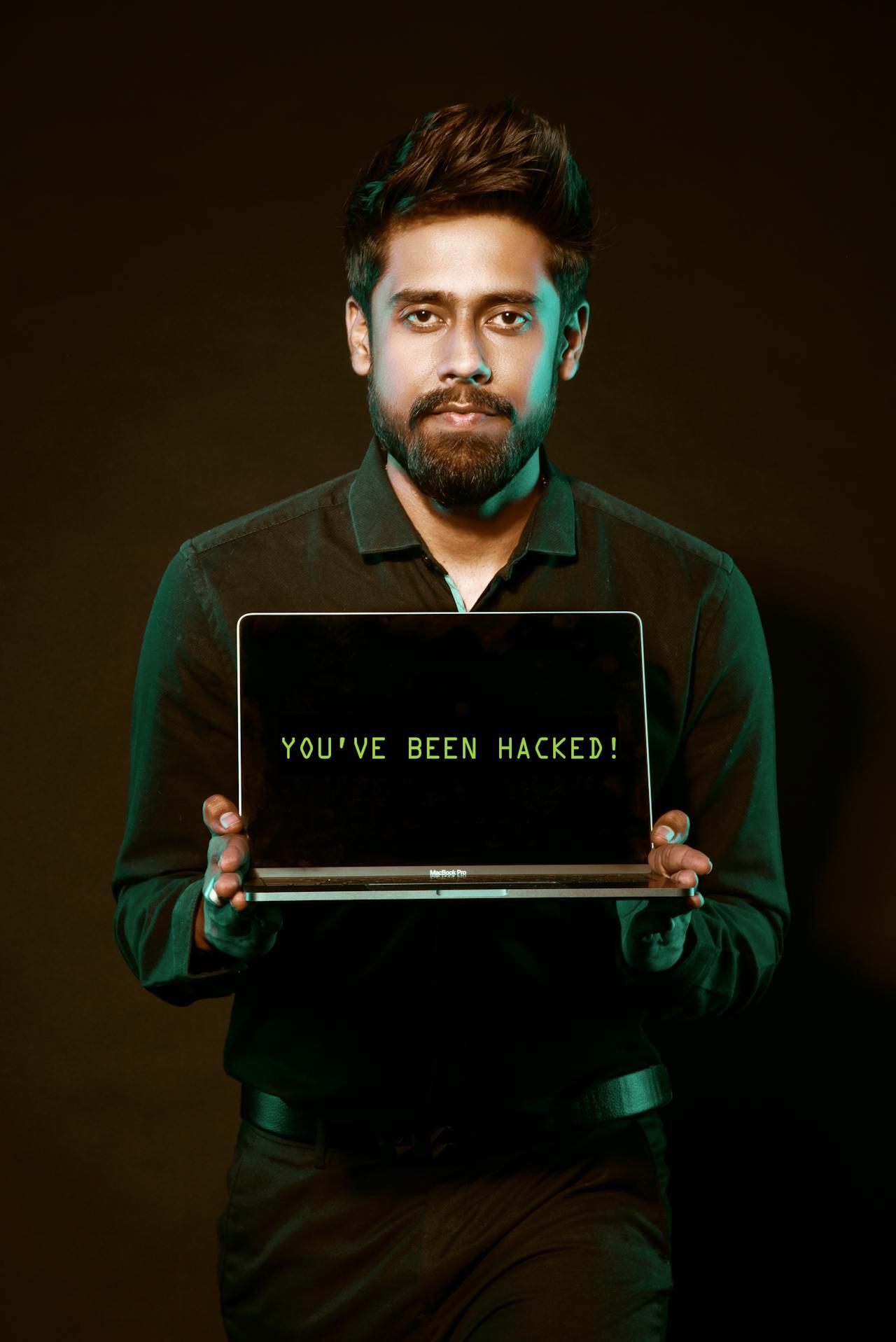 A laptop screen showing a data breach warning