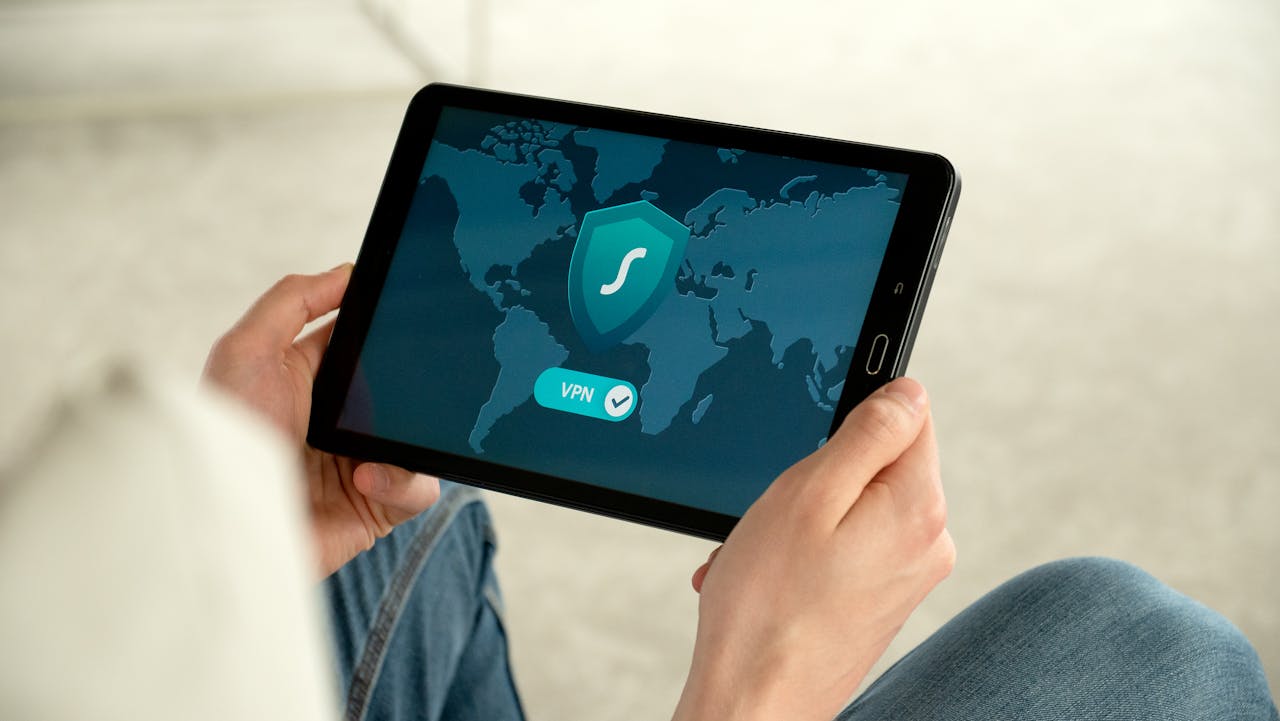 A person holding a tablet showing an online privacy and security screen