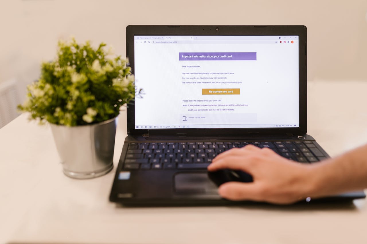 A laptop showing a suspicious phishing email about a credit card
